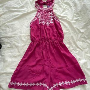 Pink romper with embroidered detail and bow tie back